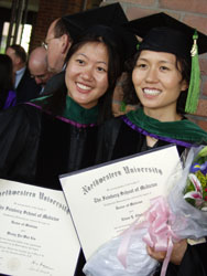 Graduates showing off their diplomas