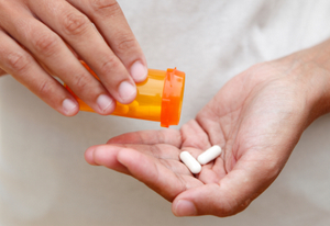 Female hand with prescription drug
