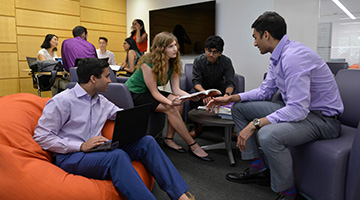 A group of students work together in the Feinberg lounge.