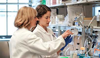 A scientist and trainee in the lab
