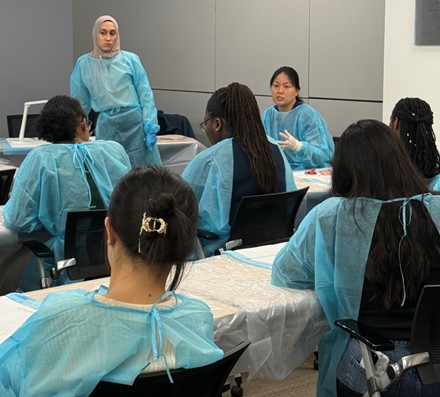 Students sitting in a classroom in blue scrubs
