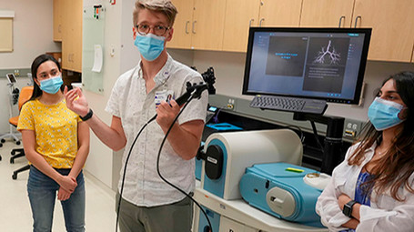 Students listening to an instructor in a clinical setting