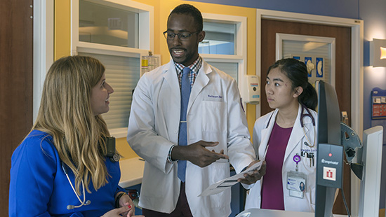 Trainees speak with their instructor after a clinical case