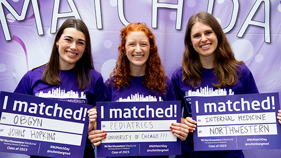 Three students celebrating match day