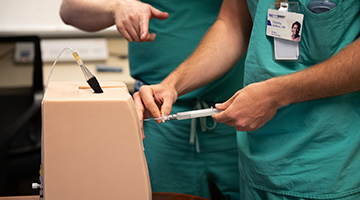 Residents train on a practice device