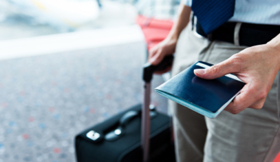 Man holding passport and luggage