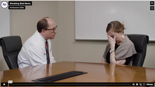 A physician comforts a medical actor to practice delivering difficult news.