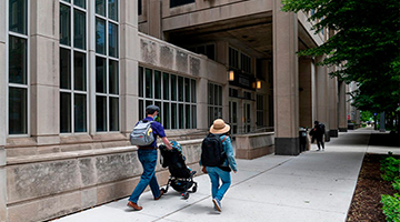 Family walking in front of the Searle Building