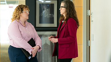 student conversing with a faculty member 