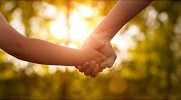 photo of two people holding hands