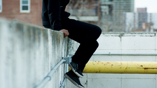 photo of kid hanging on ledge