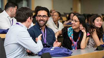 Students talk in a lecture hall