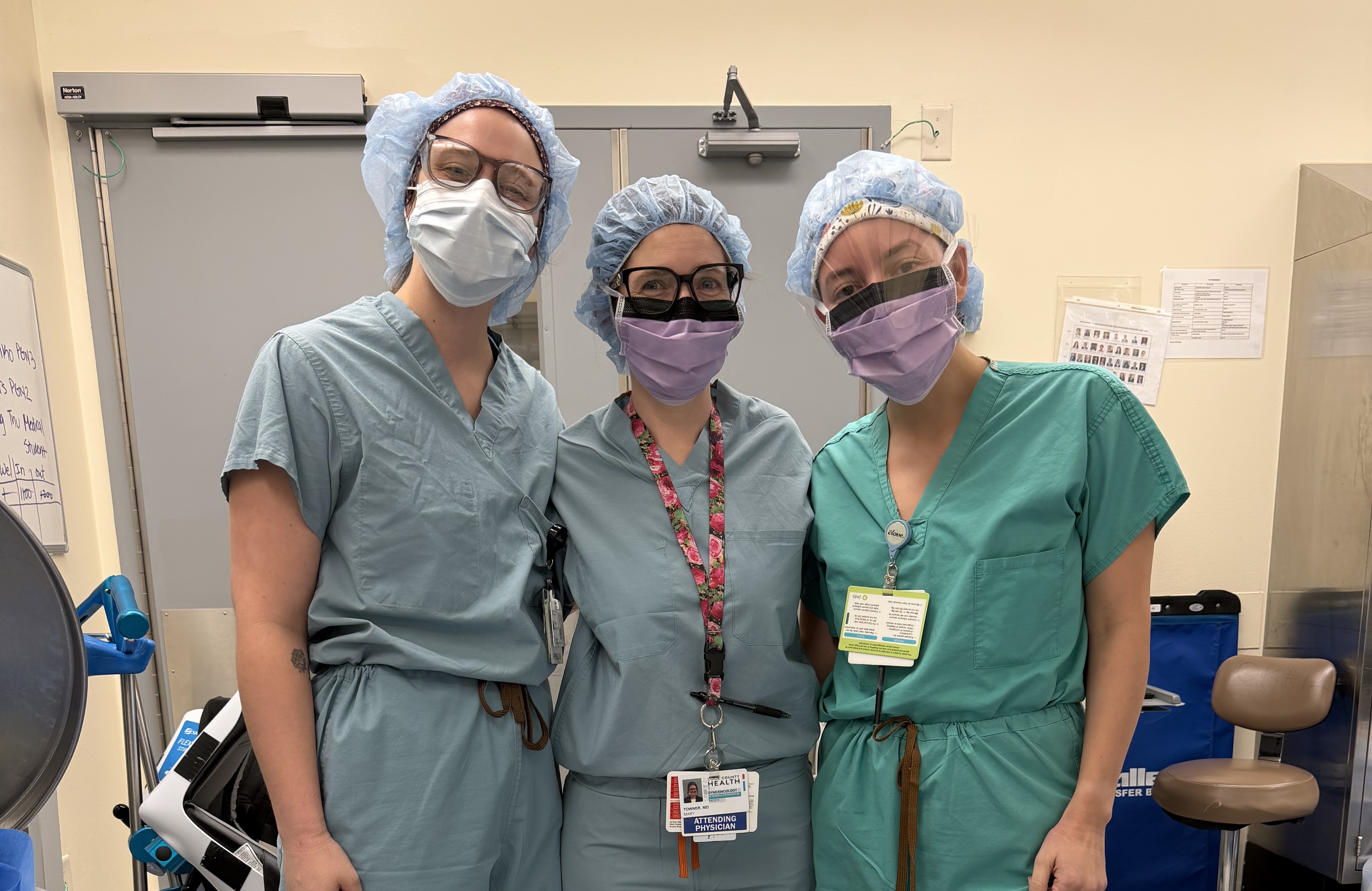 Two residents in surgical garments posing for a photo