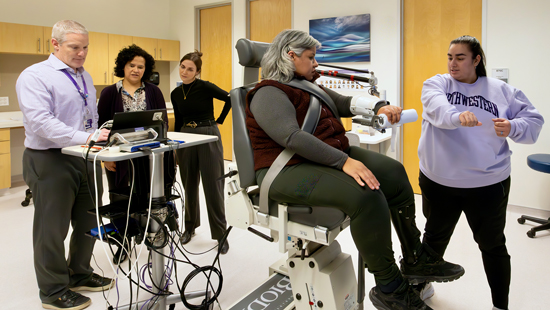 A group of PTHMS researchers working with a research subject