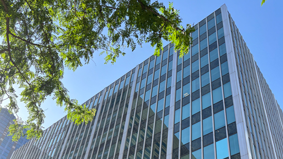 The PT department building, large grey office building, on a sunny day