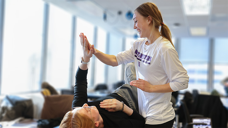 DPT student high-fiving another