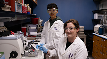 two researchers smiling 