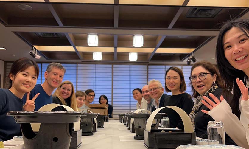 Mingzhao, Salim, Ondine, Elisabeth, Igor, Emily, Vanessa, Matt, Miikka, Li-Kun, Luisa, and Yan sitting at the dining table.