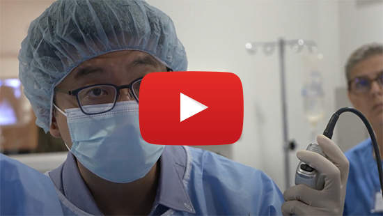 Still image from a video featuring a doctor with a video play button