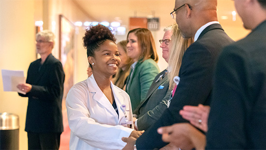 An NM Scholar shakes Dr. Yancy's hand